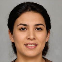 Joyful white young-adult female with medium  brown hair and brown eyes