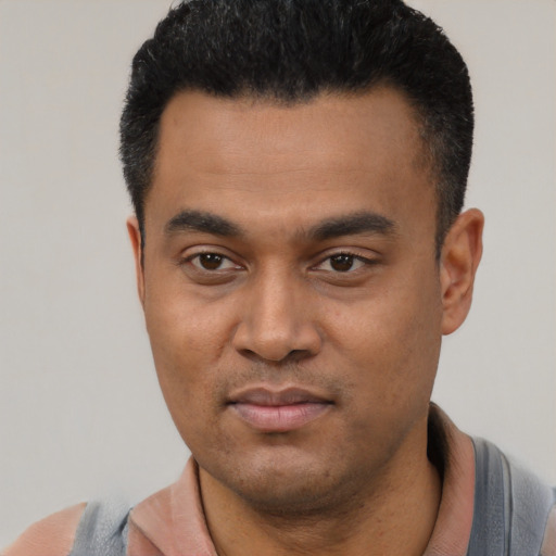 Joyful latino young-adult male with short  black hair and brown eyes