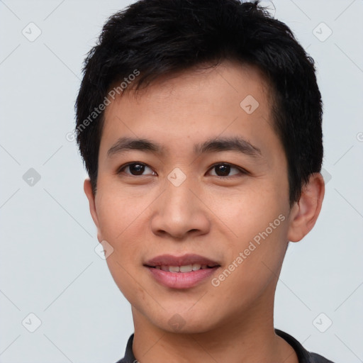 Joyful asian young-adult male with short  black hair and brown eyes