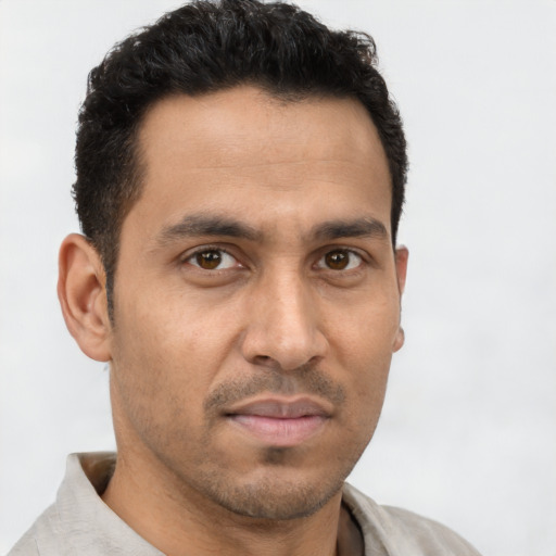 Neutral latino young-adult male with short  brown hair and brown eyes