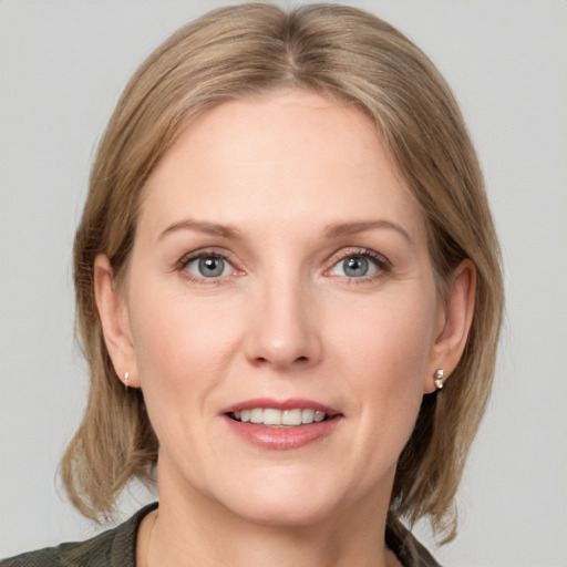 Joyful white adult female with medium  brown hair and grey eyes