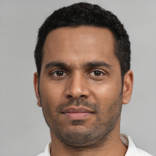 Neutral black adult male with short  black hair and brown eyes