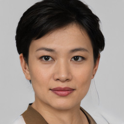 Joyful asian young-adult female with short  black hair and brown eyes