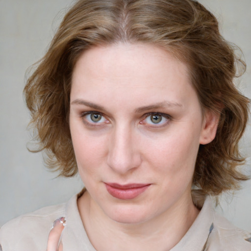 Joyful white young-adult female with medium  brown hair and blue eyes