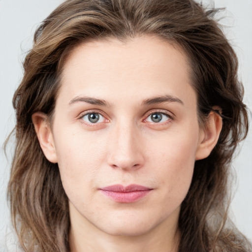 Joyful white young-adult female with medium  brown hair and blue eyes