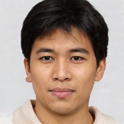 Joyful asian young-adult male with short  brown hair and brown eyes