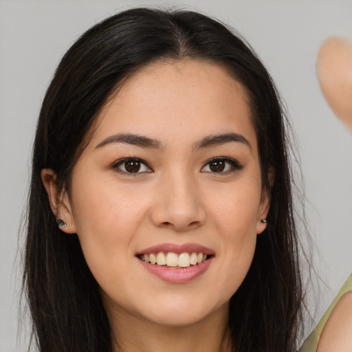 Joyful white young-adult female with long  brown hair and brown eyes