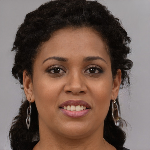 Joyful latino young-adult female with long  brown hair and brown eyes