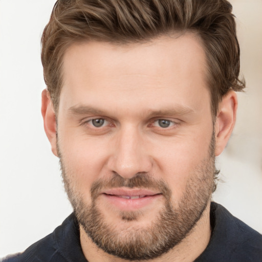 Joyful white adult male with short  brown hair and grey eyes