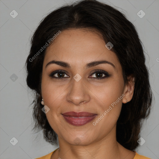 Joyful latino adult female with medium  brown hair and brown eyes