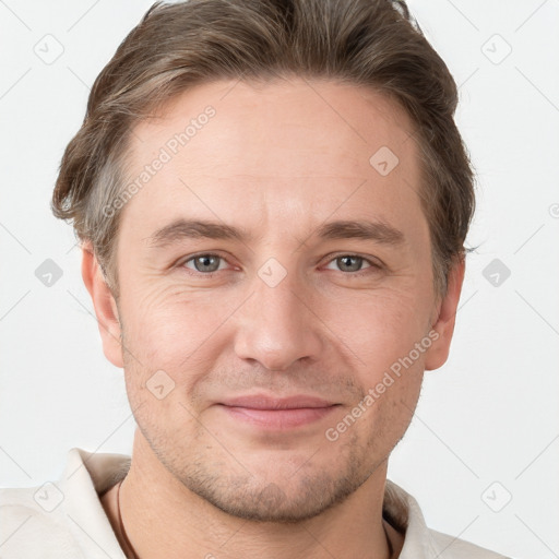 Joyful white adult male with short  brown hair and grey eyes