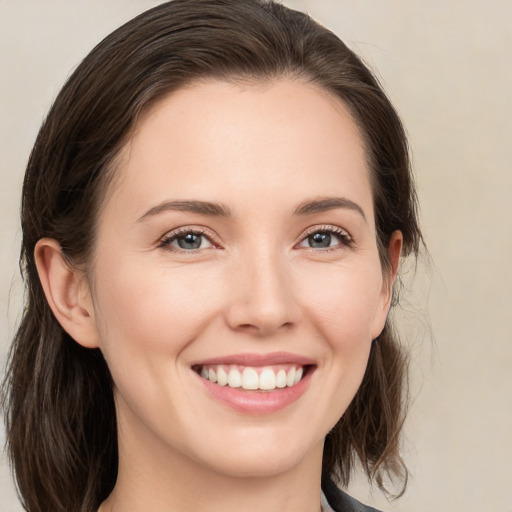 Joyful white young-adult female with medium  brown hair and brown eyes