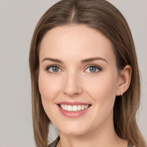 Joyful white young-adult female with long  brown hair and grey eyes