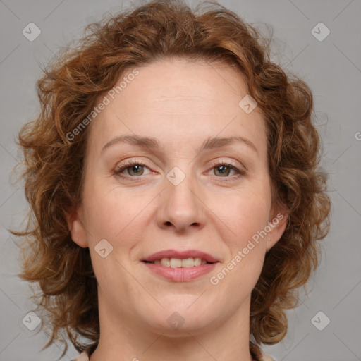 Joyful white adult female with medium  brown hair and blue eyes