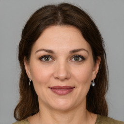 Joyful white adult female with medium  brown hair and grey eyes