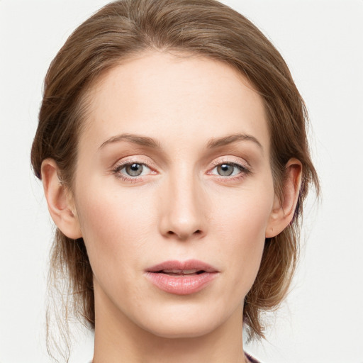 Joyful white young-adult female with medium  brown hair and blue eyes