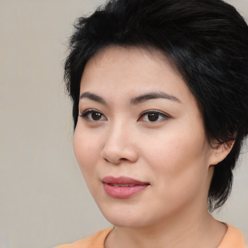 Joyful asian young-adult female with medium  black hair and brown eyes