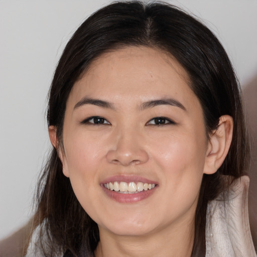 Joyful asian young-adult female with medium  brown hair and brown eyes