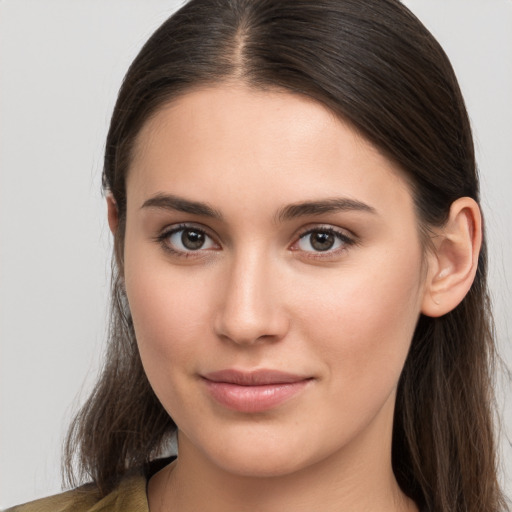 Joyful white young-adult female with long  brown hair and brown eyes