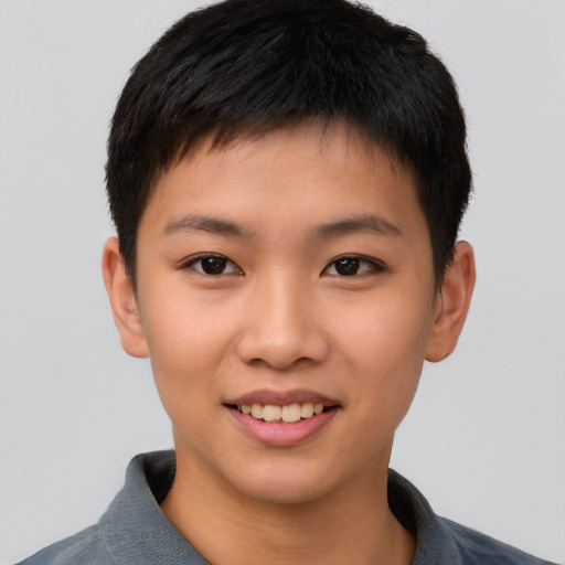 Joyful asian child male with short  brown hair and brown eyes