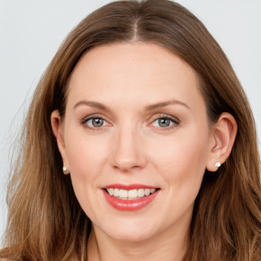 Joyful white young-adult female with long  brown hair and grey eyes