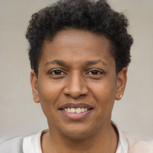 Joyful black young-adult male with short  brown hair and brown eyes