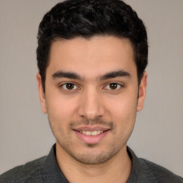 Joyful white young-adult male with short  black hair and brown eyes