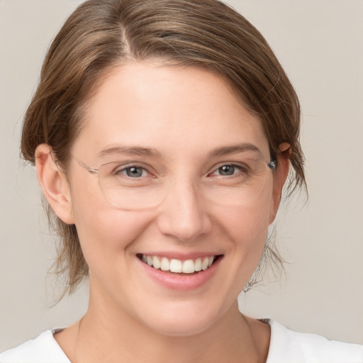 Joyful white young-adult female with medium  brown hair and grey eyes