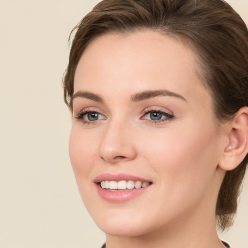 Joyful white young-adult female with long  brown hair and green eyes