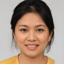 Joyful asian young-adult female with medium  brown hair and brown eyes