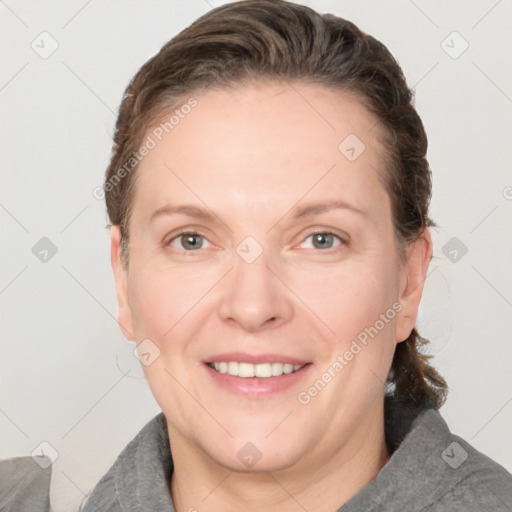 Joyful white adult female with medium  brown hair and grey eyes