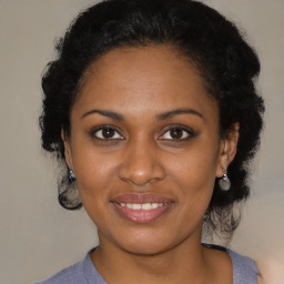 Joyful black young-adult female with medium  brown hair and brown eyes