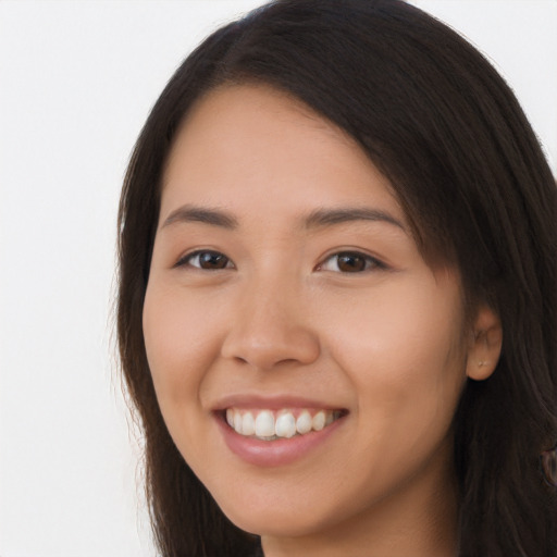 Joyful white young-adult female with long  brown hair and brown eyes