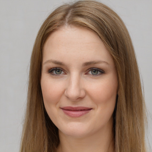 Joyful white young-adult female with long  brown hair and grey eyes