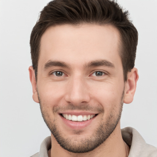 Joyful white young-adult male with short  brown hair and brown eyes