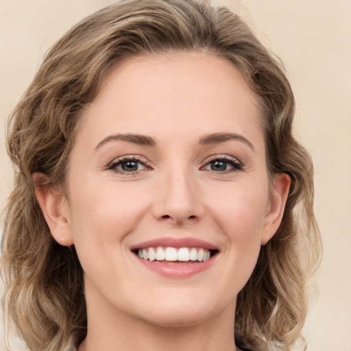 Joyful white young-adult female with medium  brown hair and green eyes