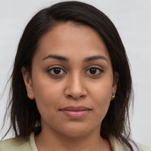 Joyful latino young-adult female with medium  brown hair and brown eyes