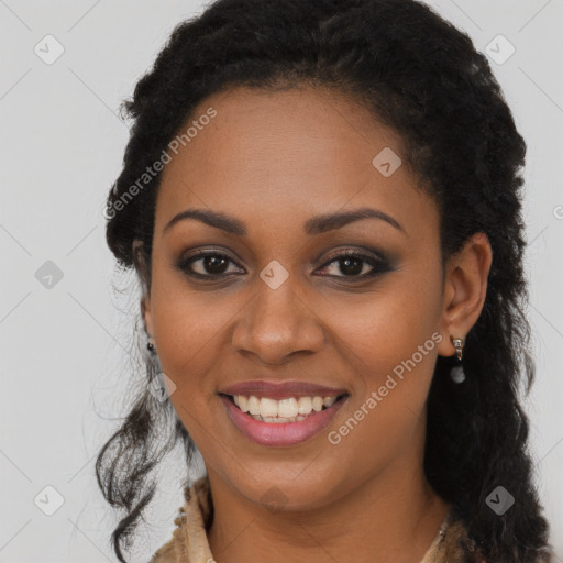 Joyful black young-adult female with long  black hair and brown eyes