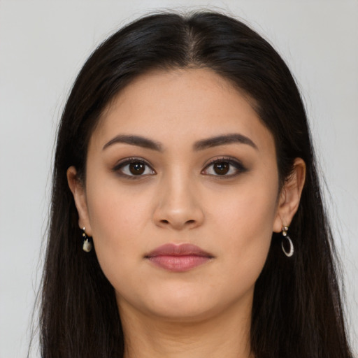 Neutral latino young-adult female with long  brown hair and brown eyes