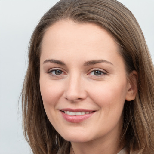 Joyful white young-adult female with long  brown hair and grey eyes