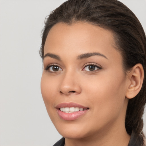 Joyful white young-adult female with long  brown hair and brown eyes