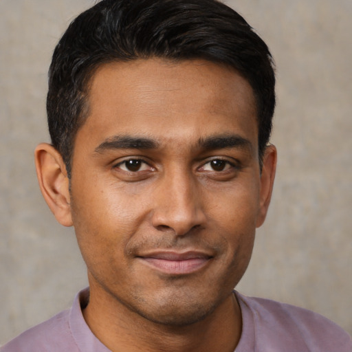 Joyful latino young-adult male with short  brown hair and brown eyes