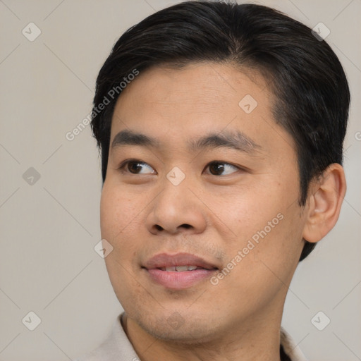 Joyful asian young-adult male with short  black hair and brown eyes