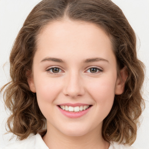 Joyful white young-adult female with medium  brown hair and green eyes