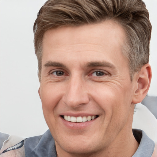 Joyful white adult male with short  brown hair and grey eyes