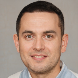 Joyful white adult male with short  brown hair and brown eyes