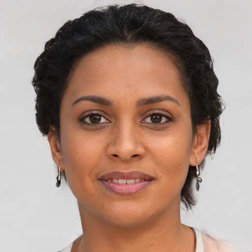 Joyful latino young-adult female with short  brown hair and brown eyes