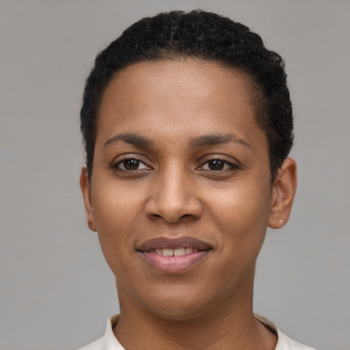 Joyful black young-adult female with short  black hair and brown eyes