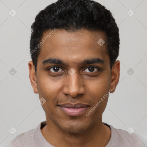 Joyful black young-adult male with short  black hair and brown eyes