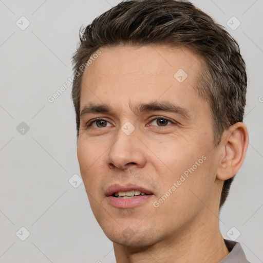 Joyful white adult male with short  brown hair and brown eyes